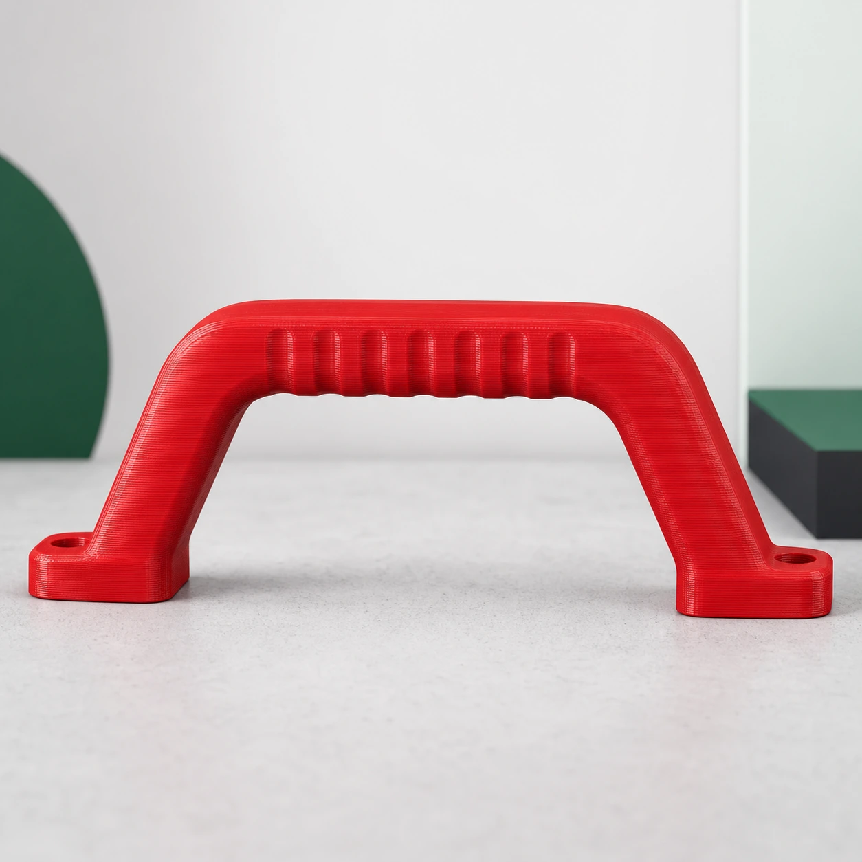Red ASA rigid outdoor carrying-handle prototype with a thick arch, broad mounting feet, and evenly spaced shallow grip ribs