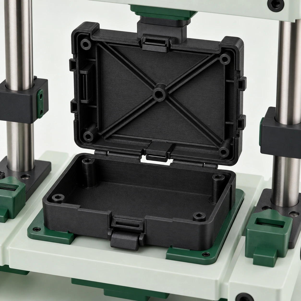 Black PAHT-CF: black PAHT-CF snap-fit enclosure opened inside a cycle-check fixture