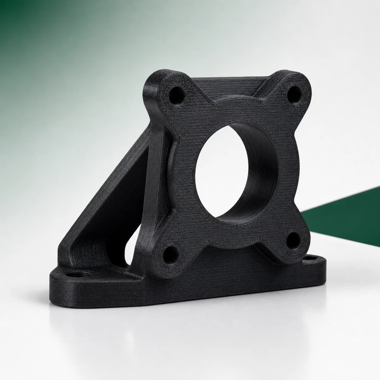 Black PAHT-CF: angular motor-mount bracket with four intact mounting ears and a central bore