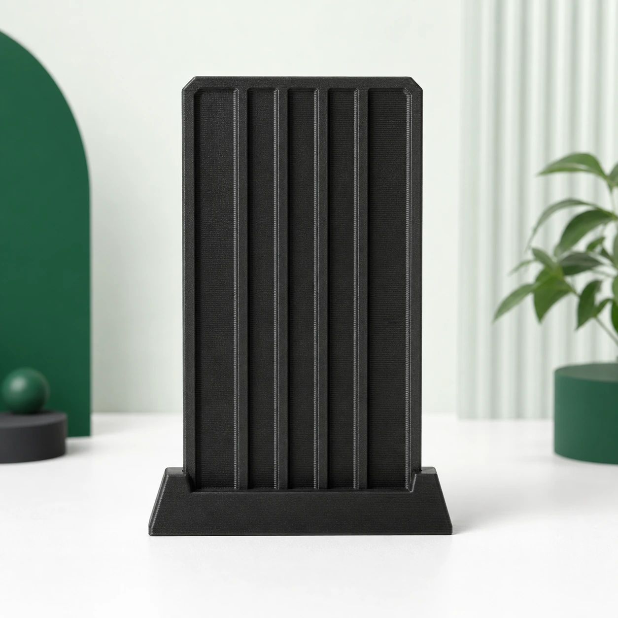 Black PAHT-CF: rectangular ribbed panel coupon held upright in a low slotted stand