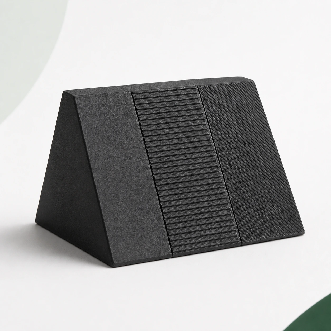 Black PAHT-CF: faceted surface-comparison prism with smooth, ribbed and diagonal FDM faces