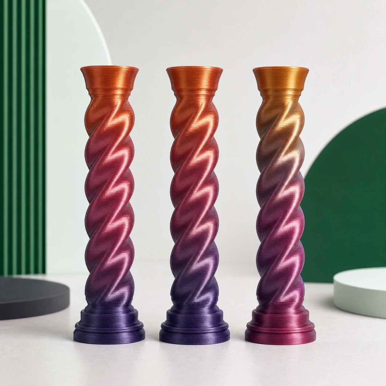 Gradient Silk Fire PLA Basic Gradient: three complete matching 3D-printed spiral columns placed together to compare transition start and repeat behavior