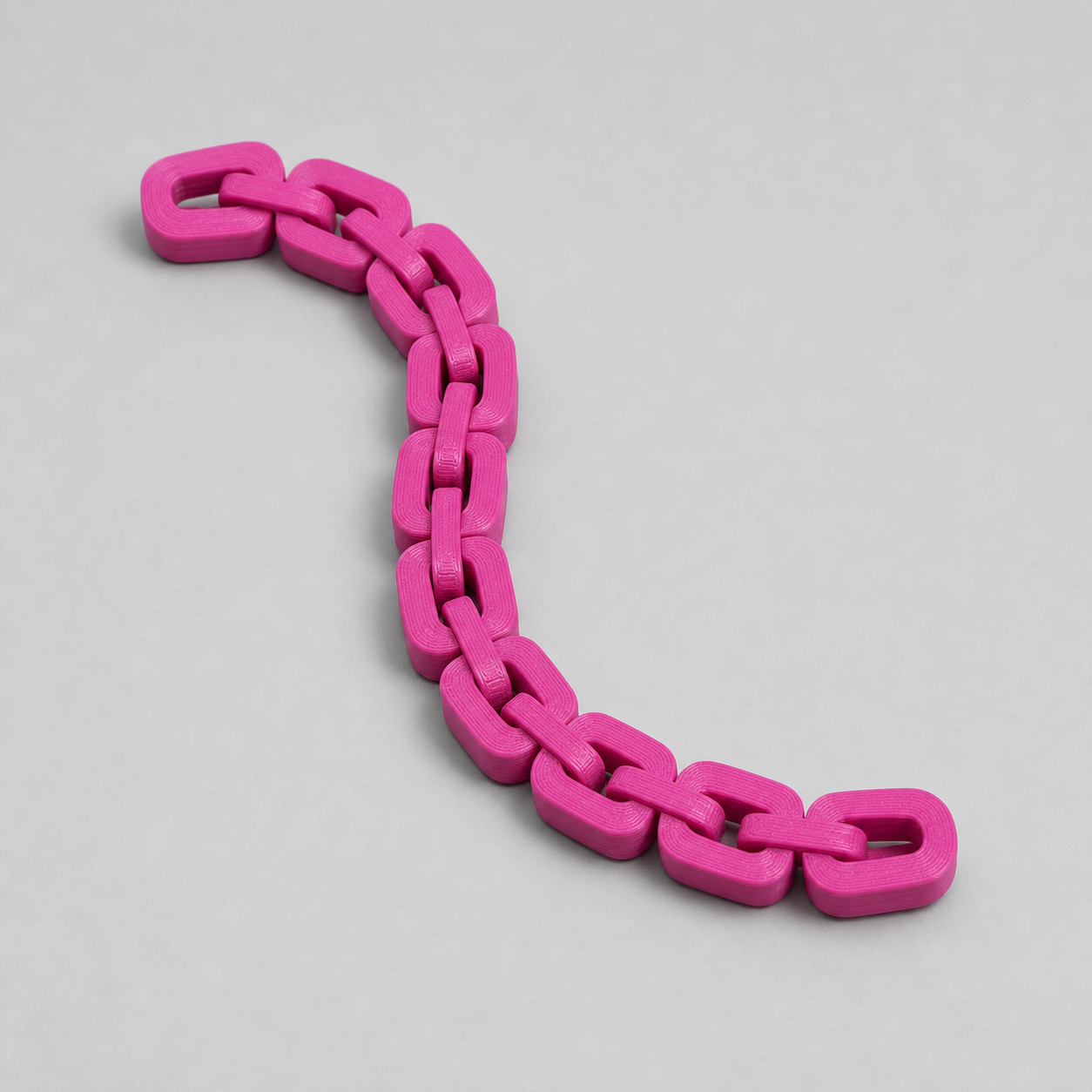 Magenta PLA Basic linked moving-chain specimen
