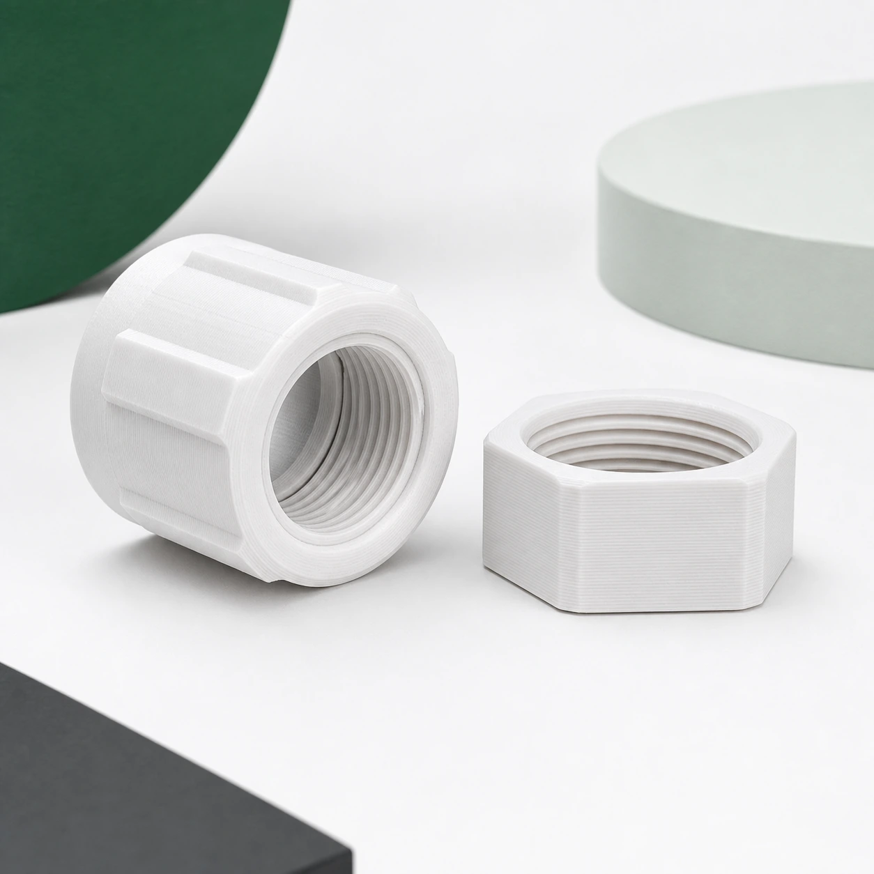 cool white PLA Tough+ complete fine-layer threaded coupling with matching captured nut seated beside it as one fit-review set